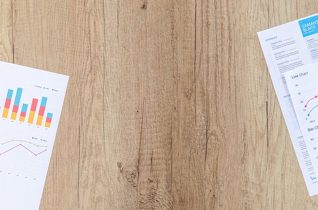 education consulting team meeting around table with documents and laptops